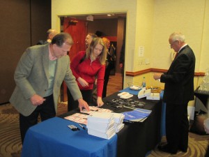 Registrants signing in received door prizes and entered name for iPad drawings