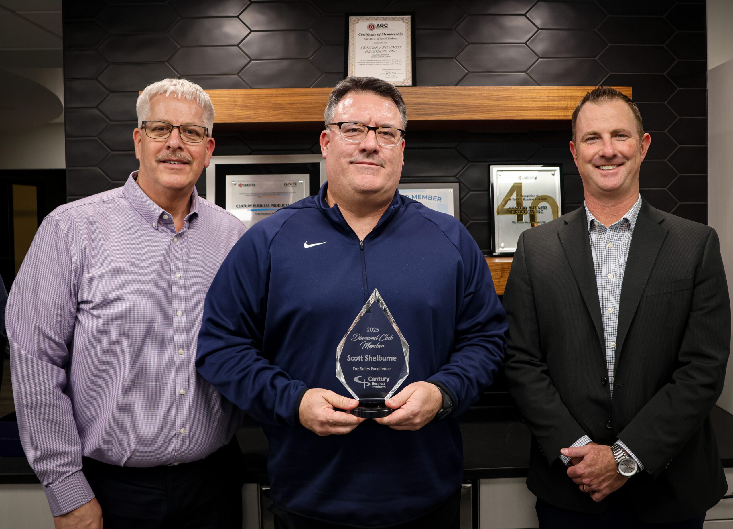 Photo of Kevin Jergenson, Scott Shelburne (holding an award), and Ryan Majors